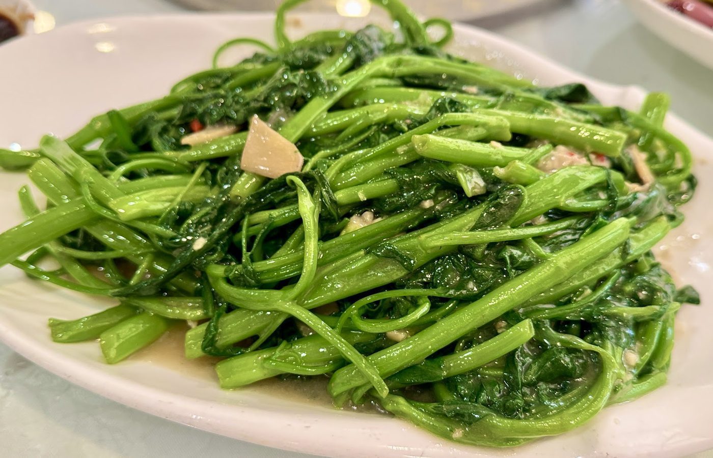Fresh leafy greens served on a white plate