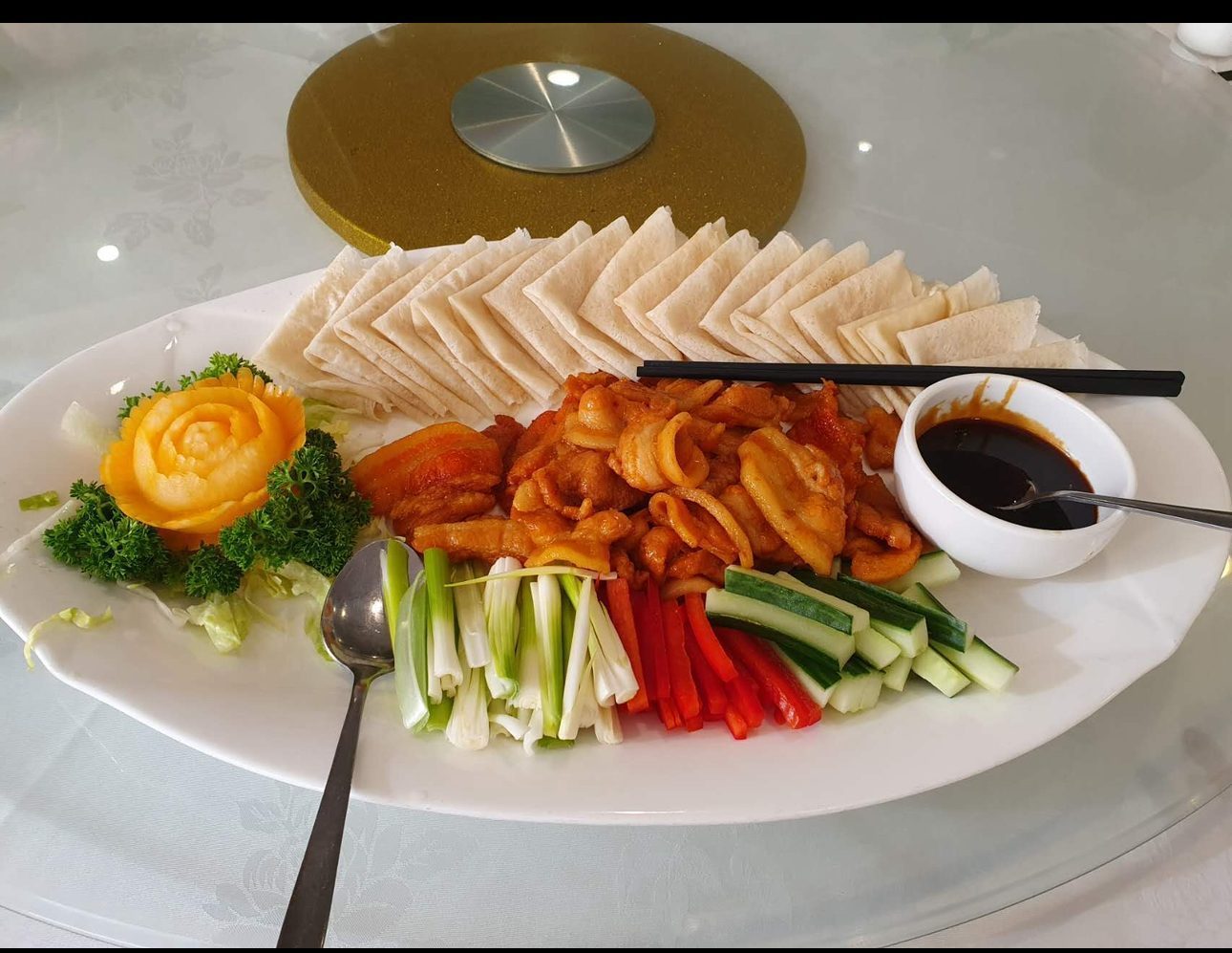 Shared Cantonese platter with sliced ingredients and dipping sauce
